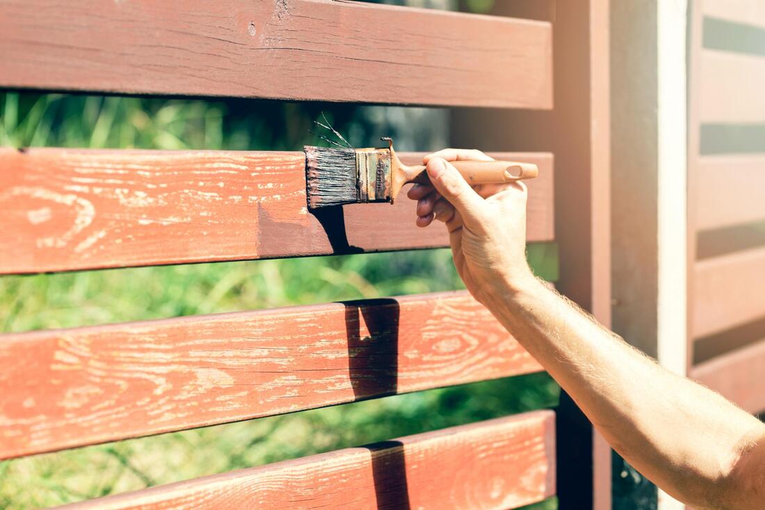 handyman doing gate painting